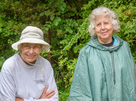 Two female professors dressed for outdoor exploration.