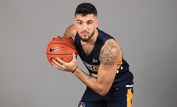 Photo of Francis Alonso posing with basketball