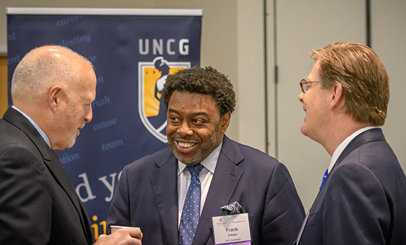 Photo of Chancellor Gilliam speaking with Leo Lambert and Vincent Price