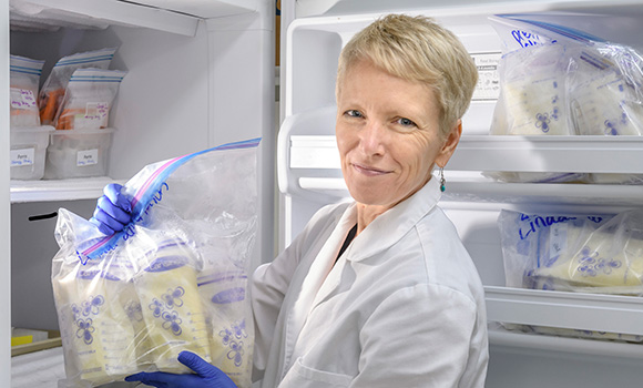 Photo of Dr. Maryanne Perrin with bags of donor milk