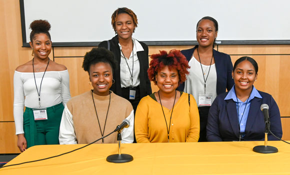 Photo of six UNCG and NC Central students standing behind a table.
