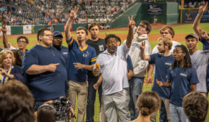 Photo of the Chancellor and others at a baseball game