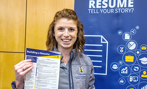 career coach holding up a resume