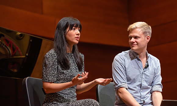 Photo of musicians on stage talking