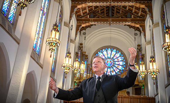 Photo of choral director in church sanctuary
