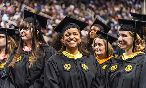 Photo of smiling graduates at December commencement