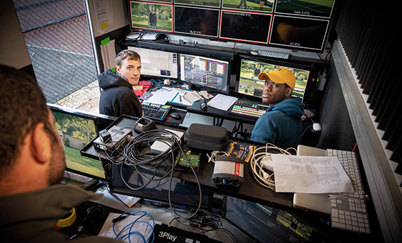Photo of students working on broadcasts inside truck