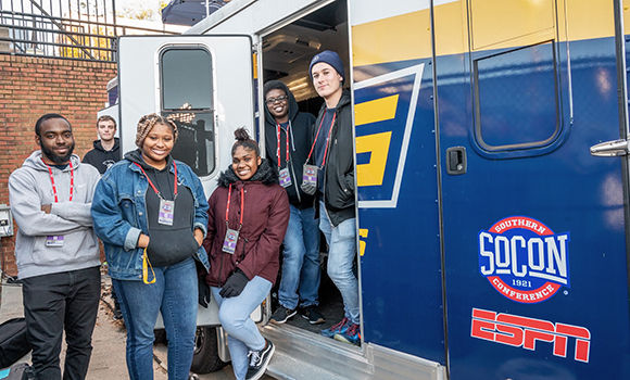 Photo of students standing in front of truck