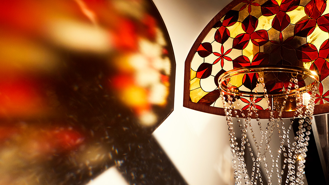 Detail photo of artwork with basketball with stained glass backboard