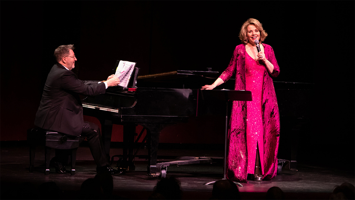 Renee Fleming singing onstage with piano accompaniment.