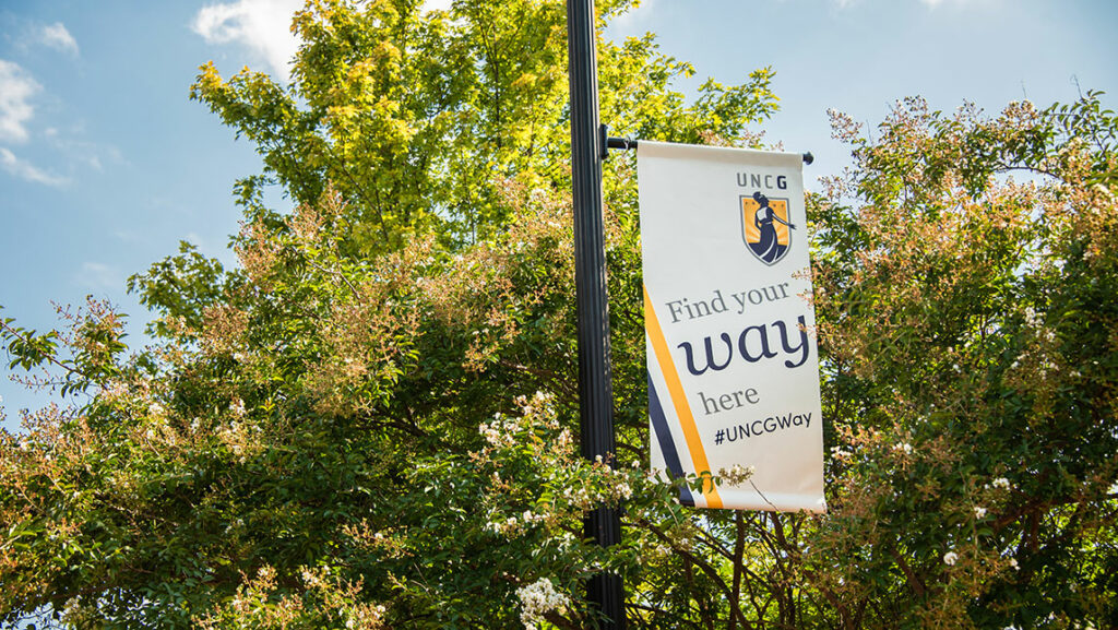 Banner that says "Find your way here" on campus