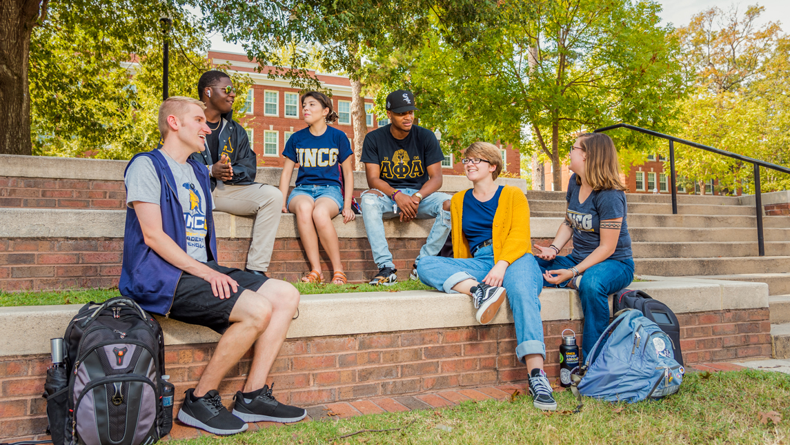 students sitting and talking on campus