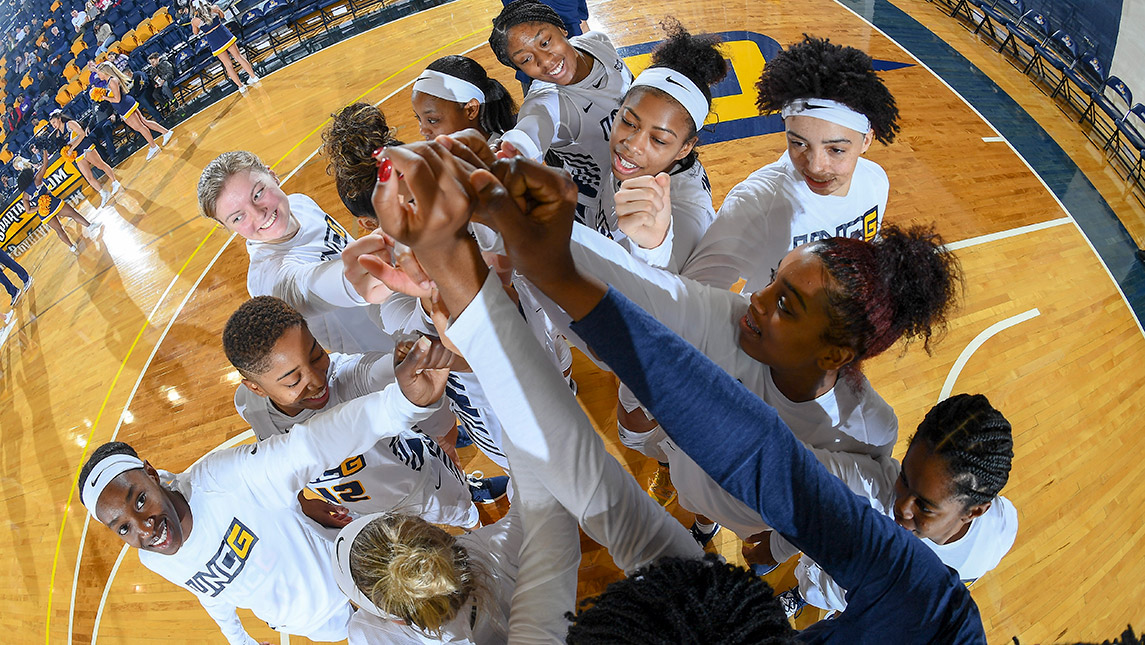 women's basketball huddle on court before game