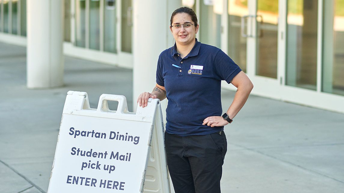 Photo of Megan Severn outside of dining hall on campus