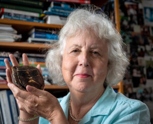 portrait of Ann Somers holding a turtle shell