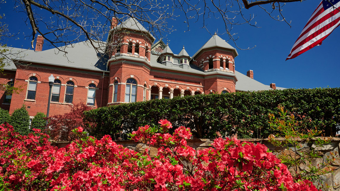 Photo of campus building and flowers