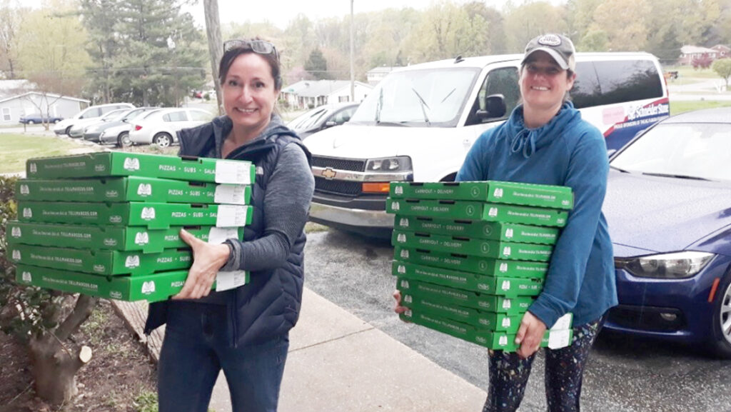 Sari Rose helps deliver pizzas to immigrant families