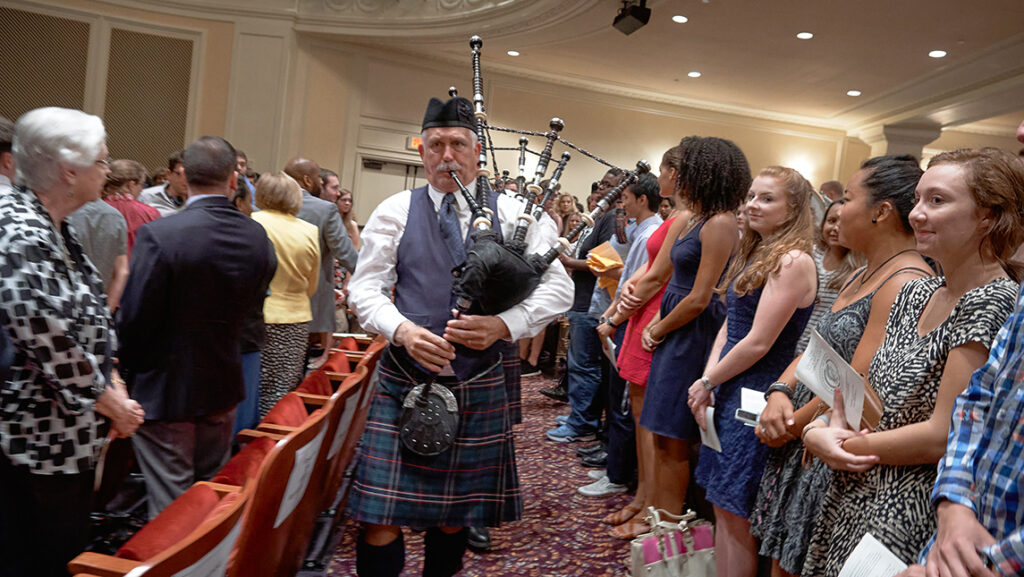 Man playing bagpipes at campus event