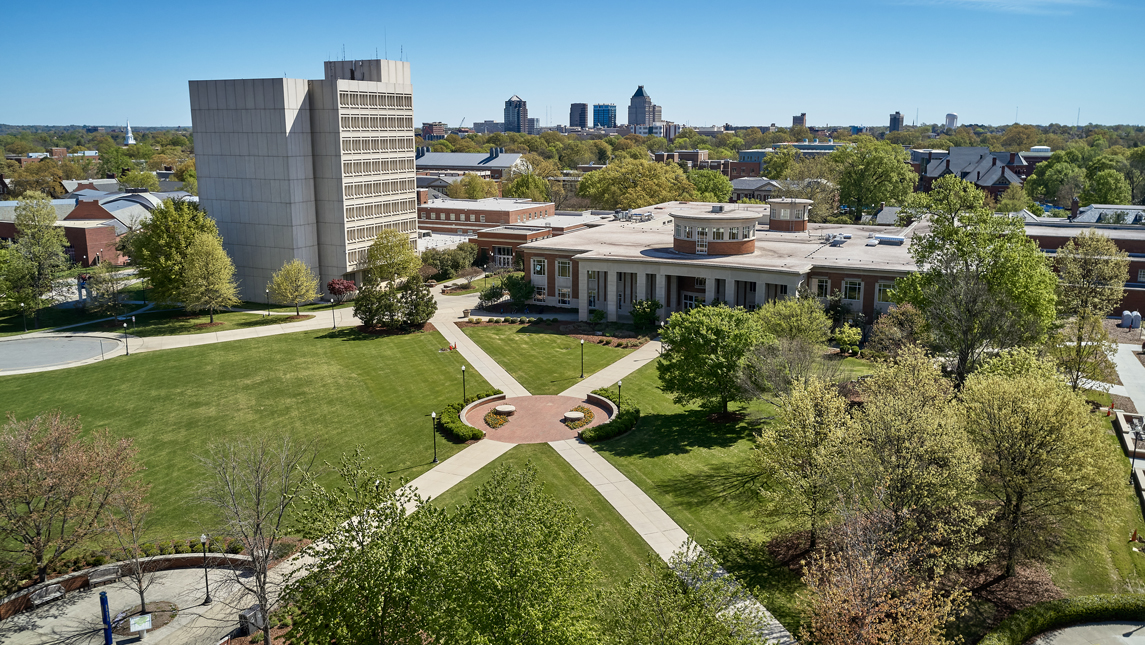 Aerial view of campus with downtown in background