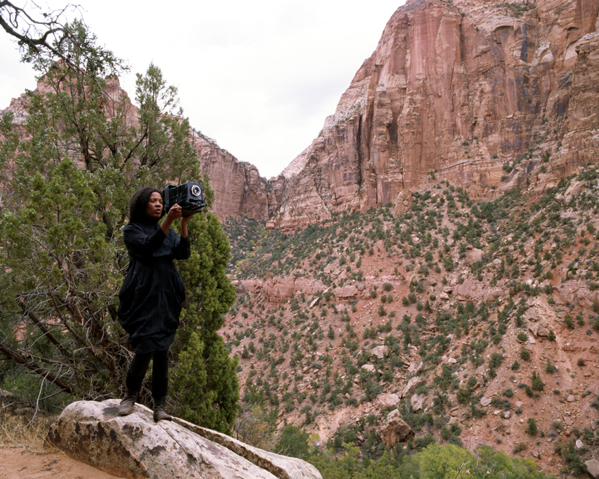 woman with camera in canyon