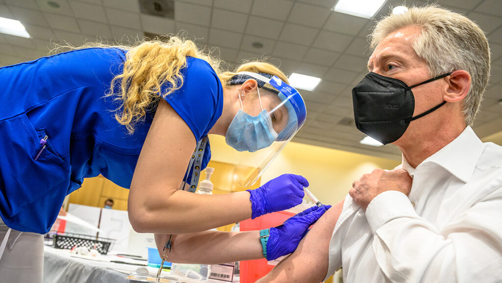 Nurse administers vaccine to UNCG employee