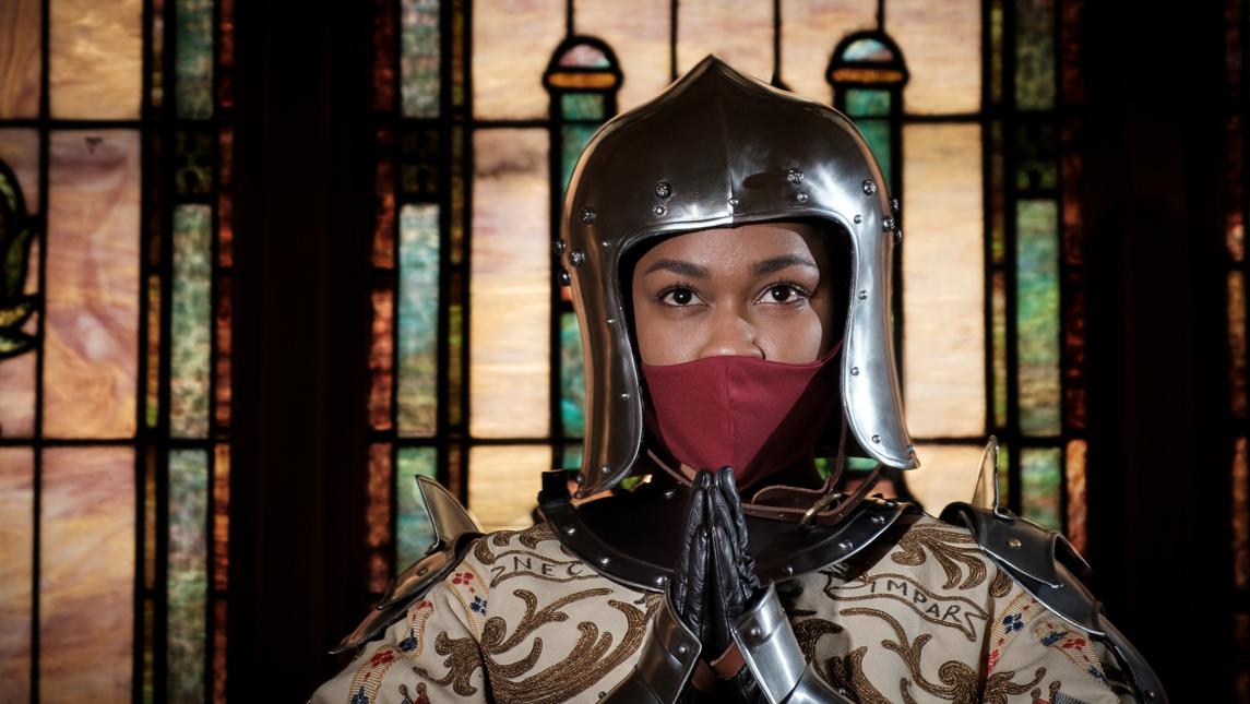 Woman in helmet in church from the UNCG Saint Joan production
