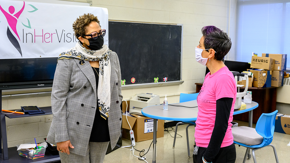 Two women speaking in classroom setting