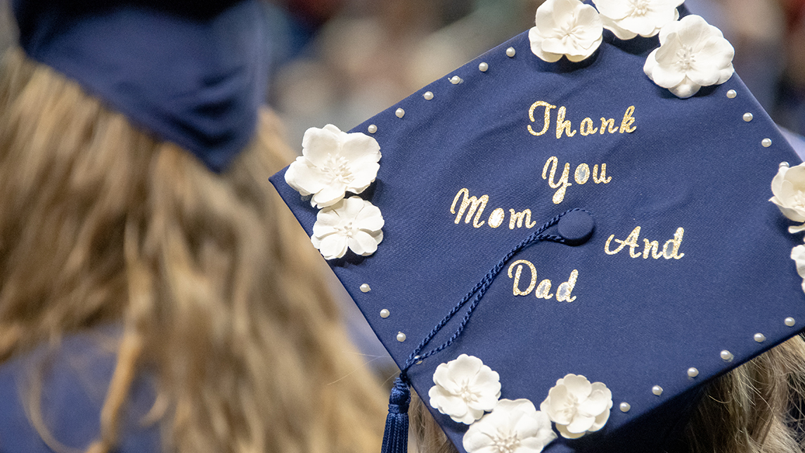 Photo of graduation cap that says "Thank you Mom and Dad."