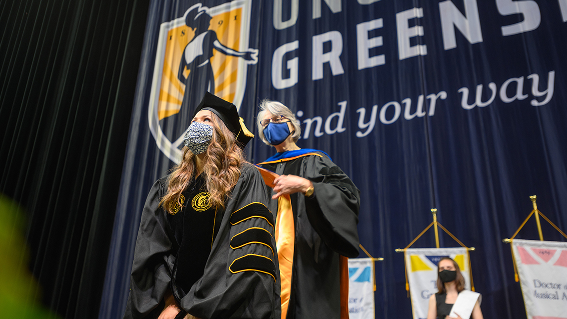 Doctoral student getting hooded at commencement