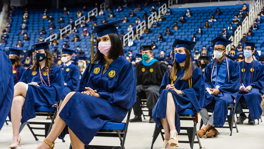 Students sitting six feet apart at commencement