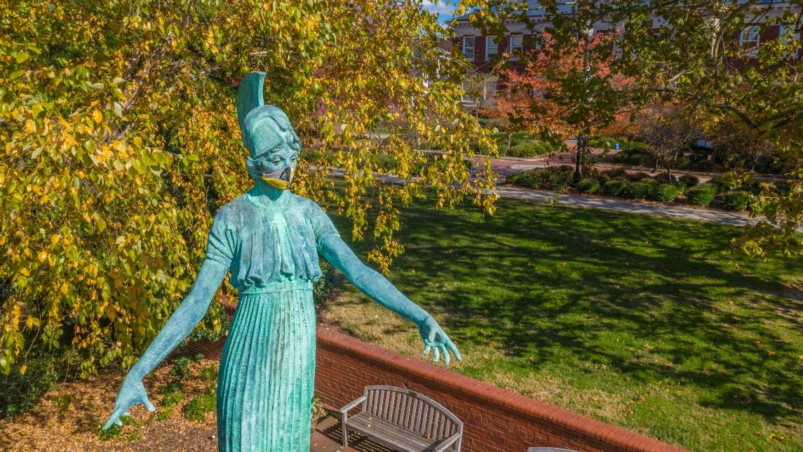 Minerva statue wearing a UNCG face covering