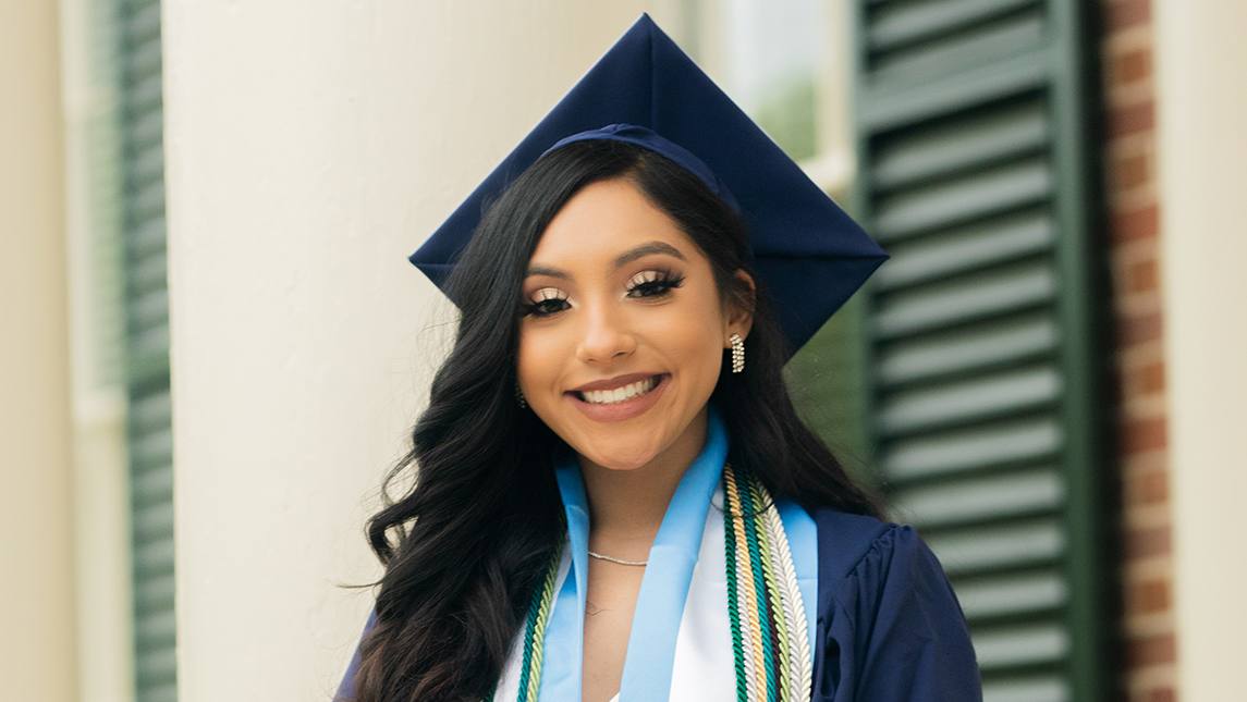 Portrait of woman wearing cap and gown