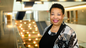 Dean Barksdale stands in front of the UNCG Nursing Instructional Building staircase.
