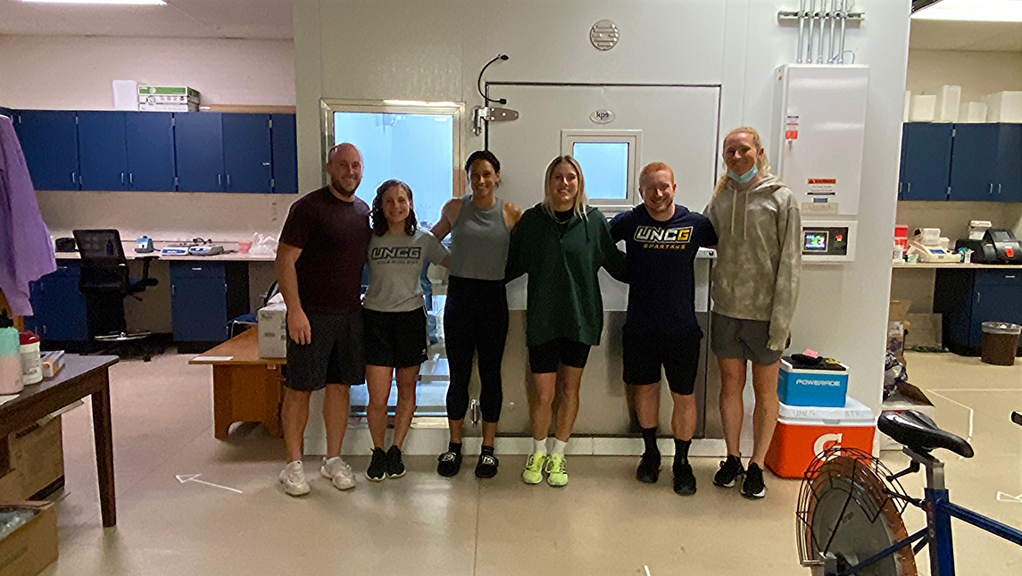 (L to R) Dr. William Adams, Emily Bechke (PhD student), Lynn Williams, Abby Dahlkemper, Mitchell Zaplatosch (PhD student), and Sam Mewis pose in the exercise physiology lab