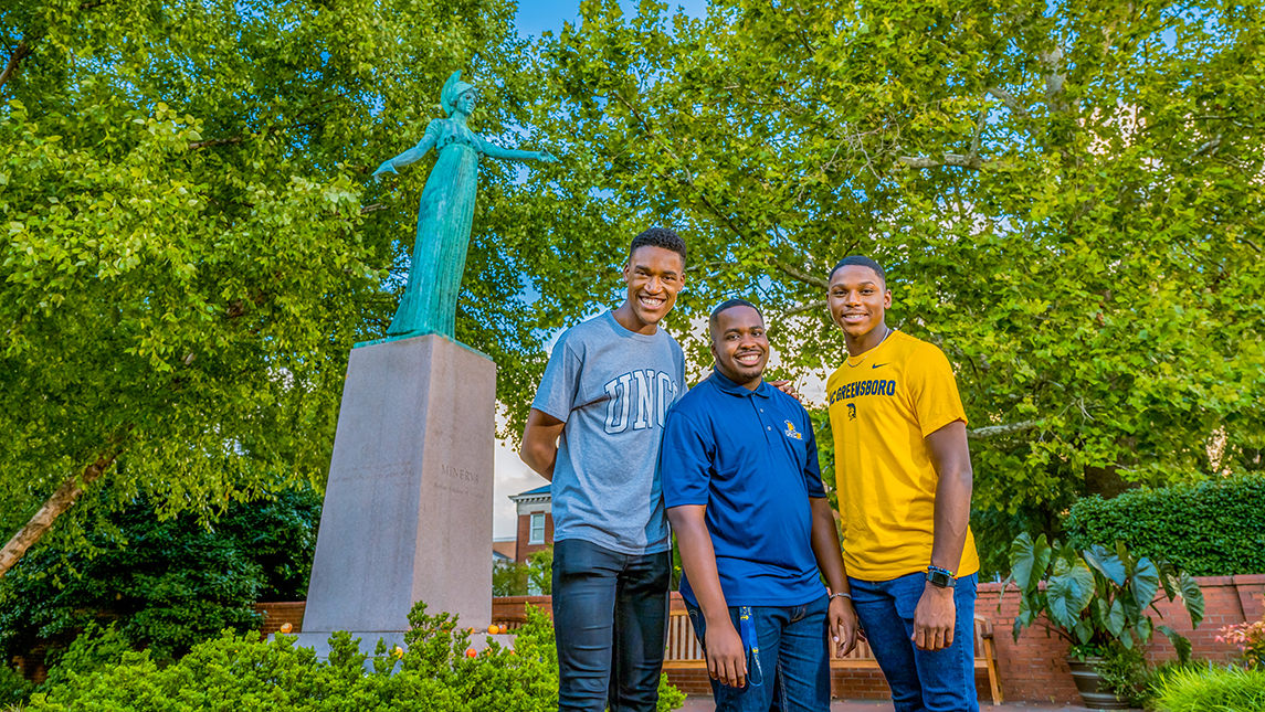 Christoff Hairston, Julian Kennedy, and Tavis Cunningham in front of Minerva Statue