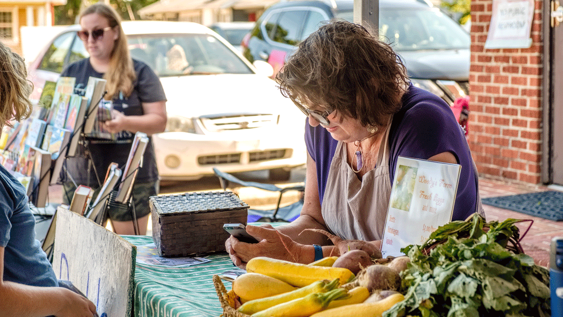 woman selling vegetables at market