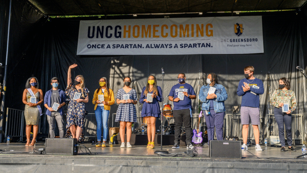 college students wearing masks on a stage