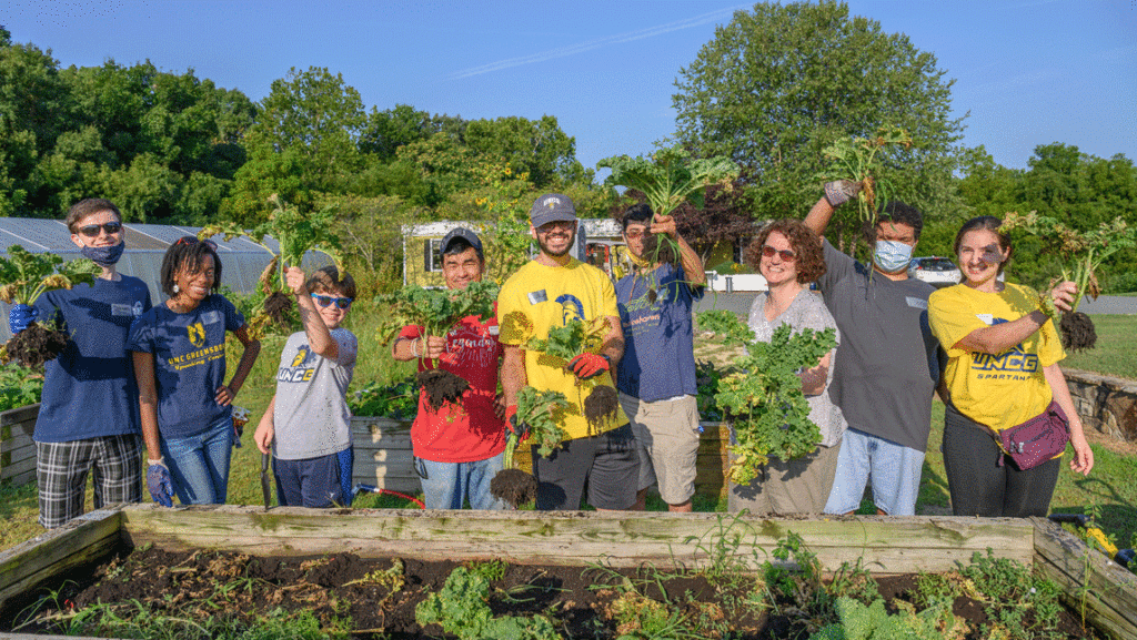 students and faculty harvesting farm crops