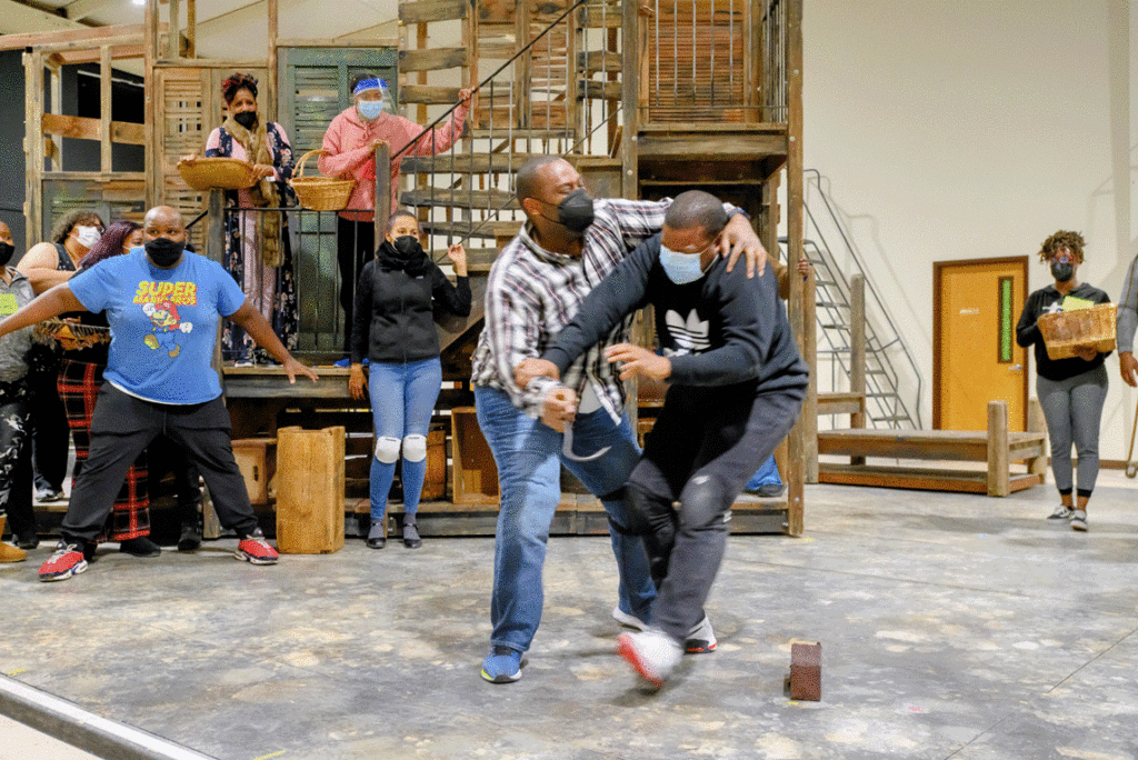 several people rehearsing on stage