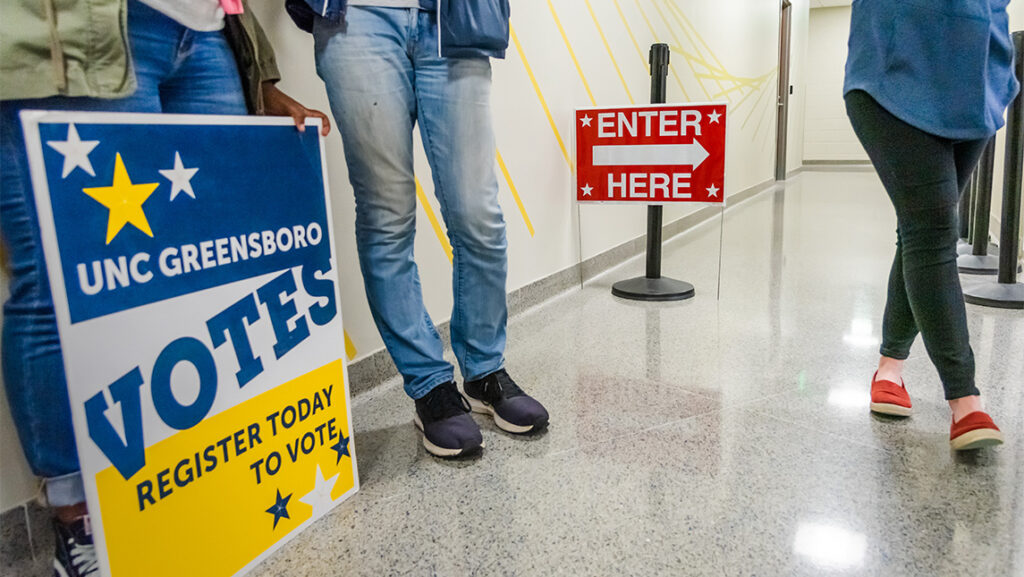 A vote sign in the hallway at UNCG.