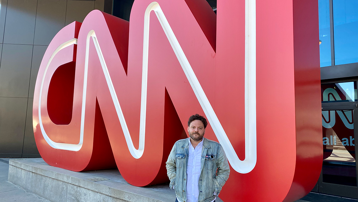 Chris Boyette standing in front of the CNN letters at CNN Headquarters in Atlanta, Georgia