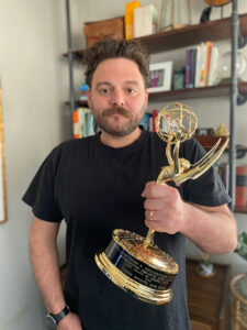 Boyette holding his Emmy Award