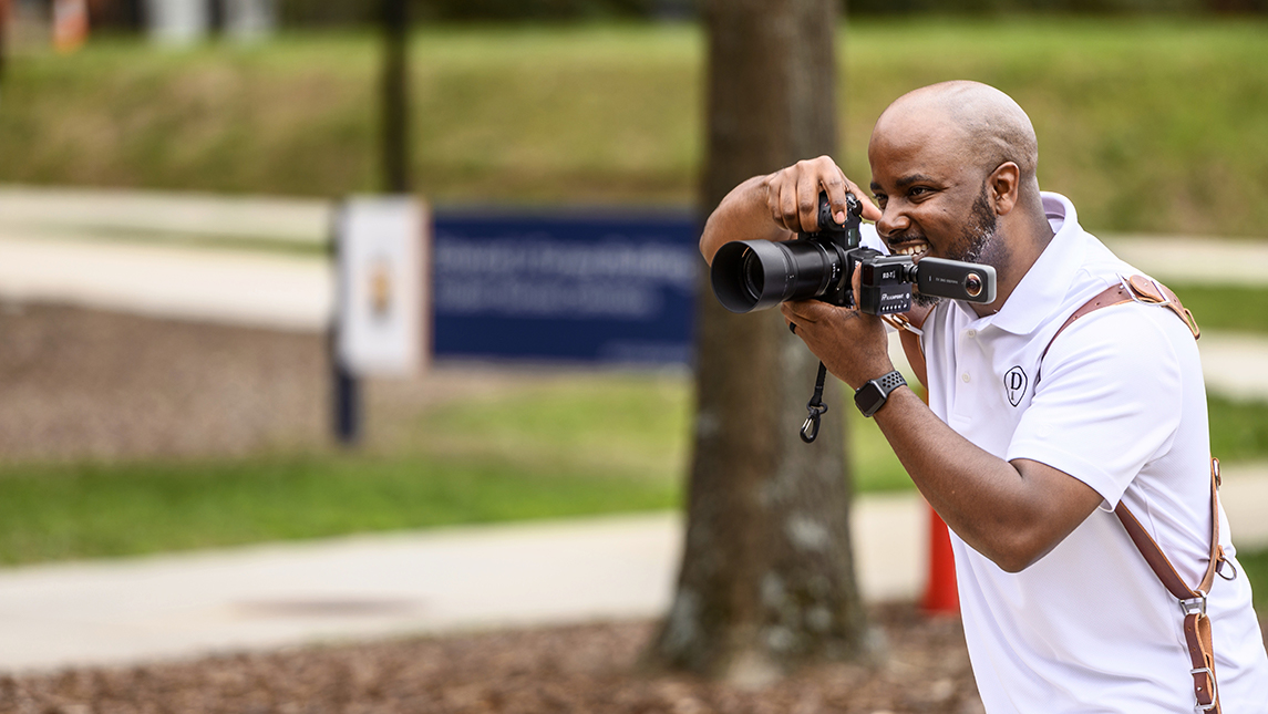 Darryl Moore holding a camera
