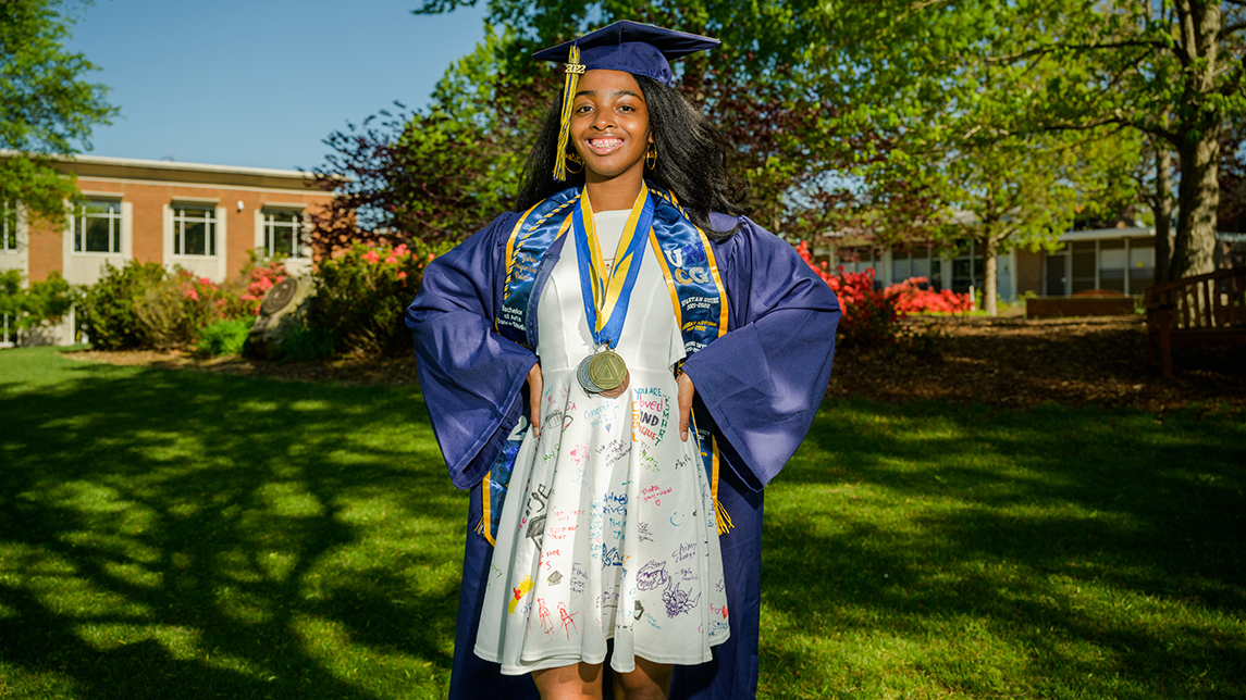 Yahira Robinson in cap and gown on Kaplan Commons