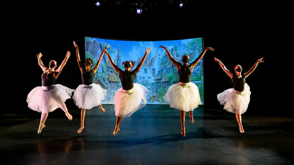 Five dancers leaping on stage