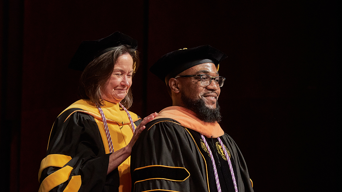 Doctoral hooding ceremony in UNCG Auditorium