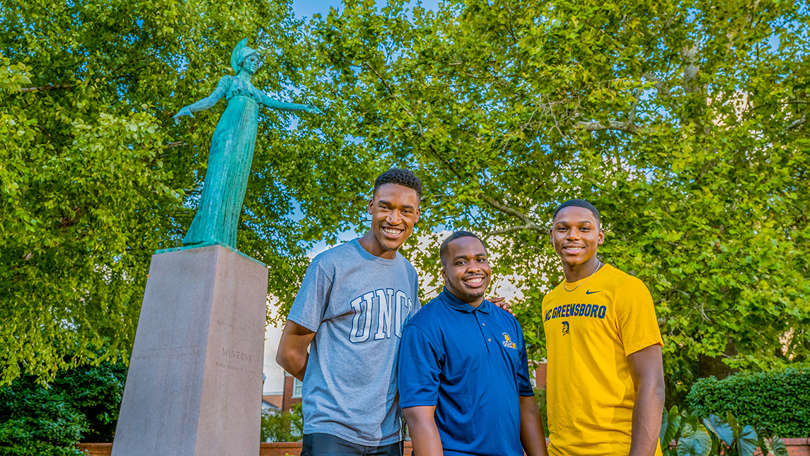 Christoff Hairston, Julian Kennedy, and Tavis Cunningham of 1aChord in front of Minerva Statue on UNCG's campus