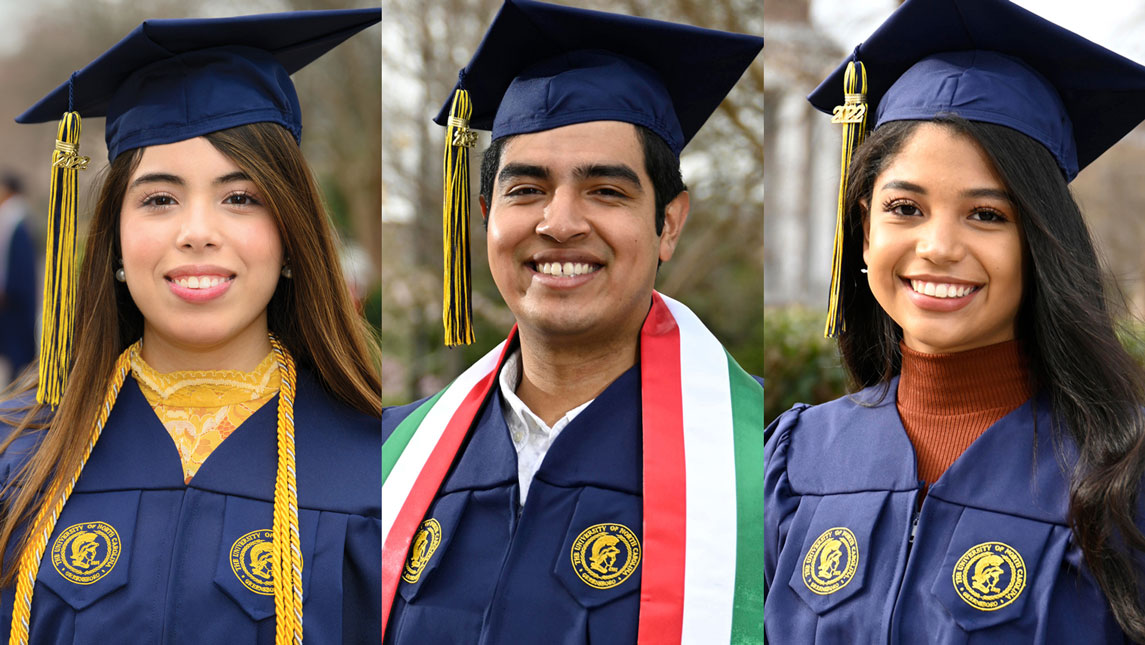 three Latinx graduates in regalia