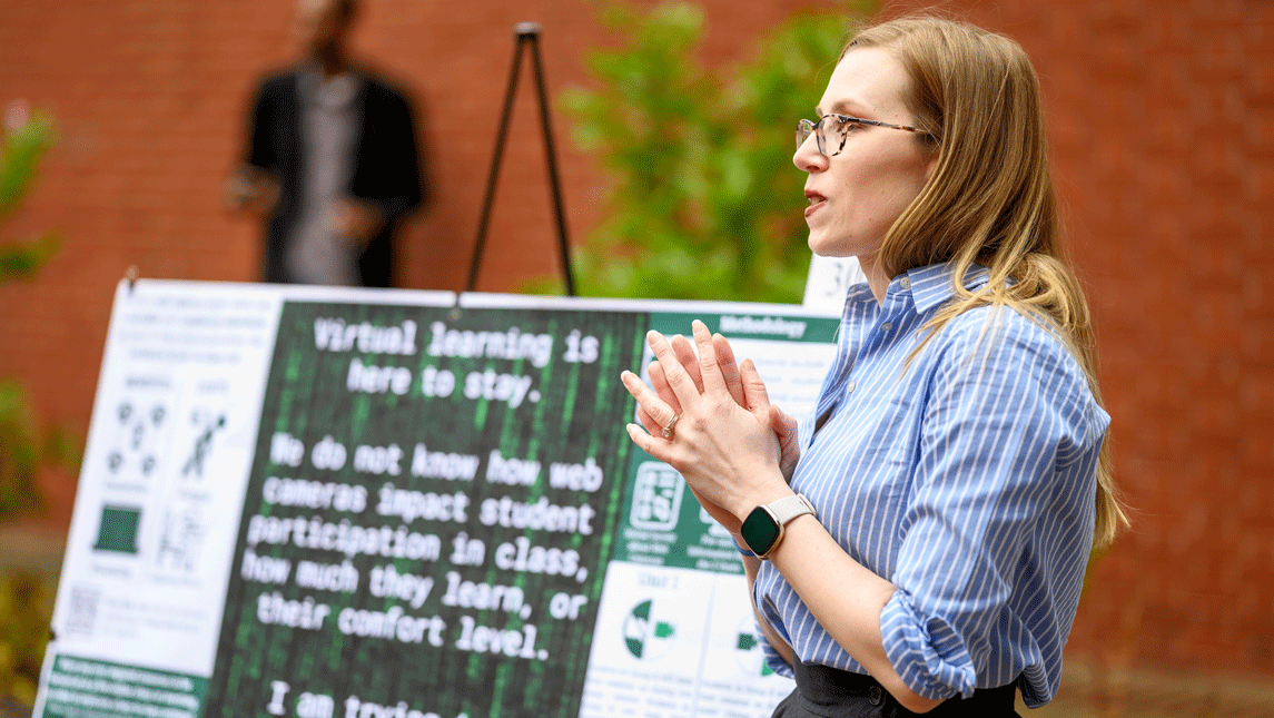A woman presents research