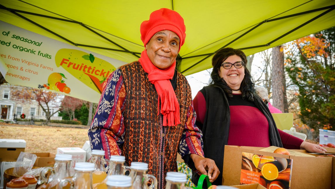 women at stand at farmers' market